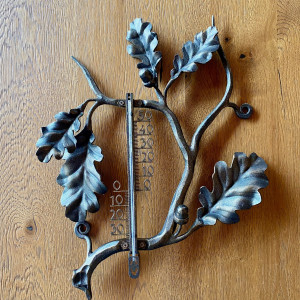 A wrought iron thermometer Oak