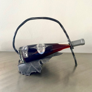 A wrought iron bottle holder