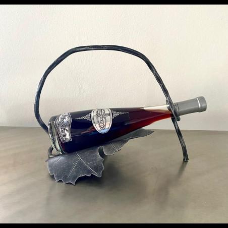 A wrought iron bottle holder