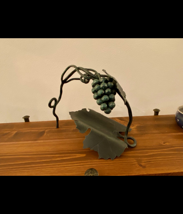 A wrought iron bottle holder