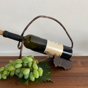 A wrought iron bottle holder