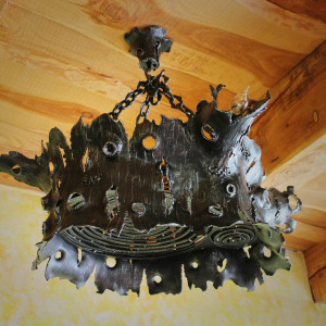 A wrought iron chandelier - an oak stump - an interior light